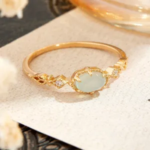 Macro view of vintage gold-plated s925 silver ring with oval green chalcedony stone