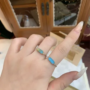 Macro detail of s925 silver gold-plated rings with rutilated quartz and turquoise
