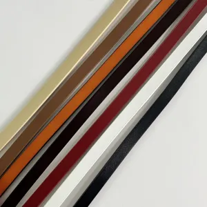 Close-up detail of multi-color slim leather belts arranged neatly for women fashion.