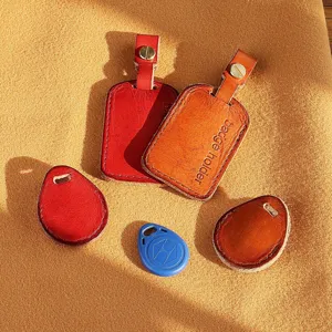 Handmade leather badge holder set, small rectangular and teardrop key ring IC card protective case detail view.