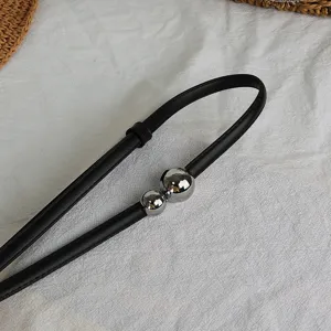 Minimalist black leather thin waist belt with shiny silver double metal balls detail.