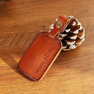 Handcrafted genuine leather badge holder detail, mini rectangular key ring with metal rivet.