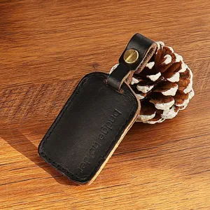 Black leather badge holder detail view, handmade small rectangular key chain accessory.