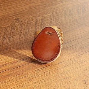 Close-up detail of handmade genuine cowhide leather teardrop key fob access card cover.