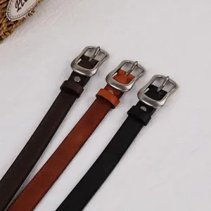 Close-up detail of genuine leather vintage pin buckle belts in black, brown and dark brown.
