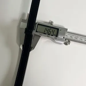 Detailed close-up shot of black leather belt width measurement using a precision digital caliper.