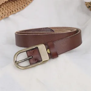 Close-up of women's genuine leather belt with retro brass buckle, slim and stylish design.