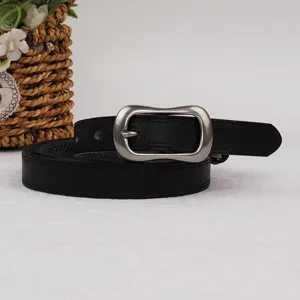 Black leather belt detail showing antique metal pin buckle and textured strap surface.
