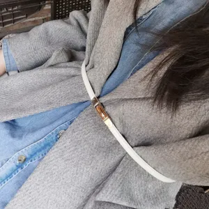 Women thin white leather belt with metal lock buckle fashion waist accessory detail shot