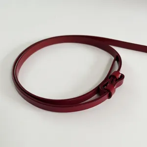 Red leather thin belt for women, simple and versatile clothing accessory detail.