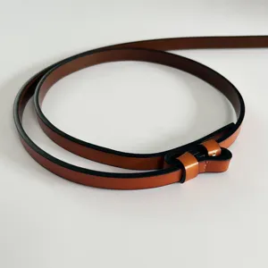 Minimalist thin leather belt for women, stylish adjustable dress waist belt with fine edges.