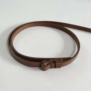 Slim brown leather belt for women, minimalist adjustable strap for dresses and sweaters daily wear.