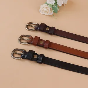 Close-up detail of slim genuine leather women belts featuring vintage metal pin buckles.