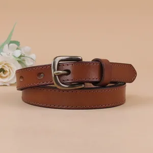 Detail view of women's brown leather belt with retro pin buckle, perfect for dresses and jeans.