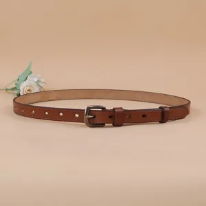 Detailed view of the brown leather belt with vintage metal pin buckle and punched holes.