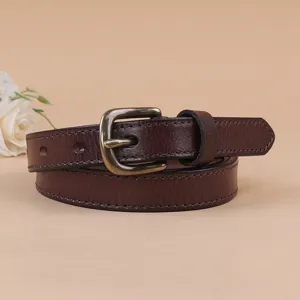 Close-up detail of dark brown women genuine leather belt with antique bronze pin buckle.