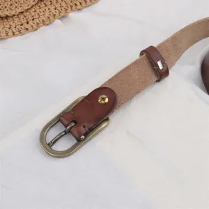 Detailed shot of brown genuine leather belt with vintage brass metal pin buckle close up.
