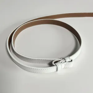 Detailed close-up view of a slim white leather belt showing fine stitching and elegant loop.