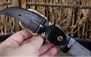 Close-up view of genuine leather belt detail showing metal buckle and retro craftsmanship.
