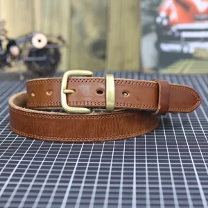 Classic retro brown genuine leather belt with brass metal buckle, perfect for casual denim jeans.