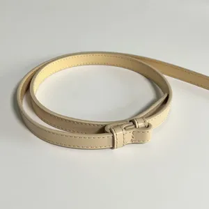 Elegant genuine leather thin waist belt for women dress styling, minimalist adjustable design.