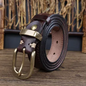 Detailed view of women's vintage brown leather belt with retro brass metal buckle.
