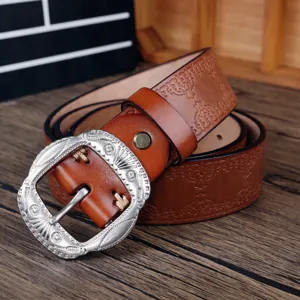 Detailed view of a retro men's brown cowhide leather belt featuring a carved silver metal pin buckle.