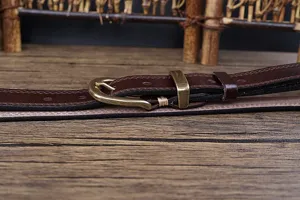 Vintage brown genuine leather women's belt detail, featuring a classic metal buckle.