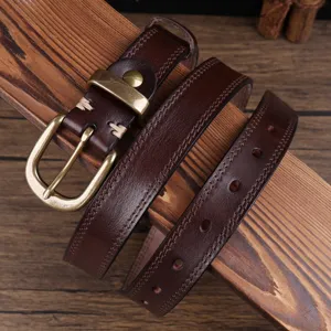 Detail view of a vintage brown genuine leather women's belt with classic brass buckle.