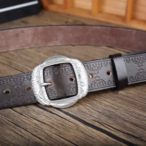 Vintage genuine leather belt for men with ornate metal pin buckle and embossed tooling pattern detail.