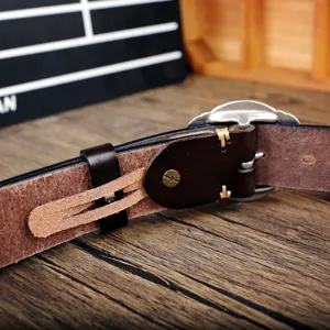 Close-up detail of retro genuine leather men belt with pin buckle and contrast stitching.