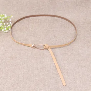 Detailed view of the thin leather waist belt showcasing its delicate teardrop metal loop buckle.