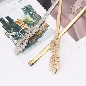Detail view of the stylish elastic metal waist chain with a delicate leaf buckle design.