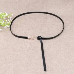Slim black leather belt featuring a delicate water drop metal buckle and knot detail for dresses.