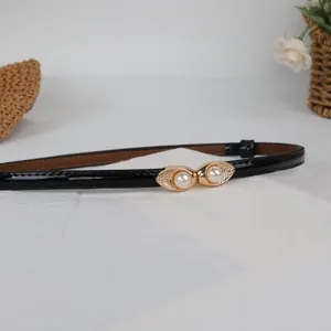 Sweet pearl buckle thin belt for women dresses, versatile black patent leather accessory detail.