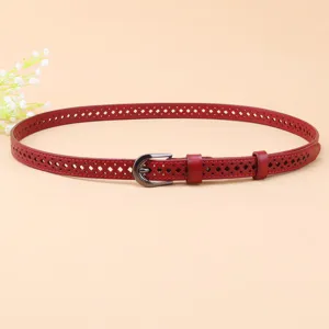 Red hollow leather belt for women, elegant thin strap with metal buckle, dress dress accessory.