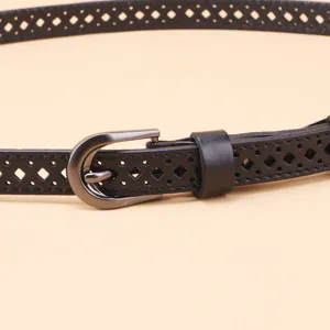 Close-up detail of a women's black hollow leather belt featuring a chic metal buckle and cutouts.