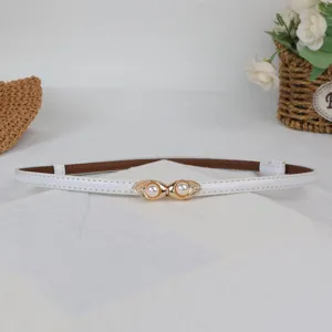 Detailed close-up of a sweet white leather skinny belt featuring an elegant pearl metal buckle.