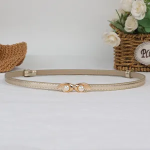 Elegant women's gold skinny belt with pearl metal buckle, perfect for dresses and sweaters.