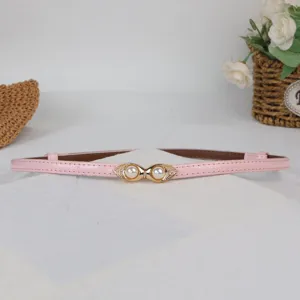 Close-up of pink thin leather belt with elegant pearl metal double buckle detail for women.