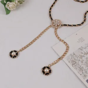 Elegant gold metal chain belt with black interwoven leather, pearl and crystal floral decor.
