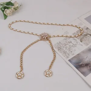 Elegant gold chain belt for women with pearls and camellia flower, ideal for dresses and suits.