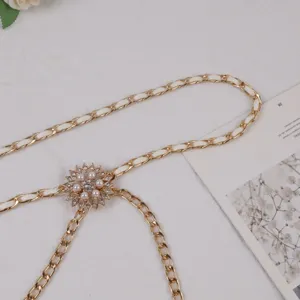 Women gold and white interwoven chain belt with pearl rhinestone flower buckle waist decoration.