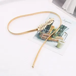 Gold metal waist chain detail shot, elegant leaf buckle, elastic slim belt for women dress.