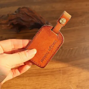 Detailed close-up view of handmade cowhide access card sleeve with metal hardware.