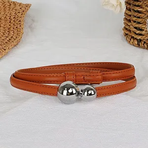 Detail of women's brown thin leather belt featuring stylish silver ball double buckle design.