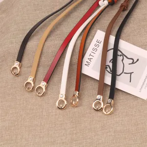 Detailed view of thin leather waist belts with metal ring buckles in various colors.