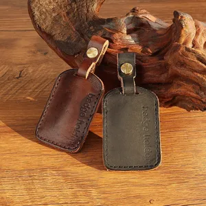Handmade genuine leather badge holder card sleeve keychain detail showing fine stitching and brass screw.