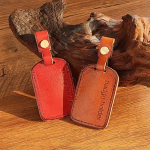 Close-up of handmade leather badge holders and key card covers with metal screw details.
