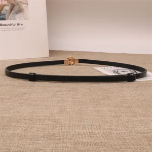 Minimalist thin leather belt for women, featuring gold buckle and adjustable design.